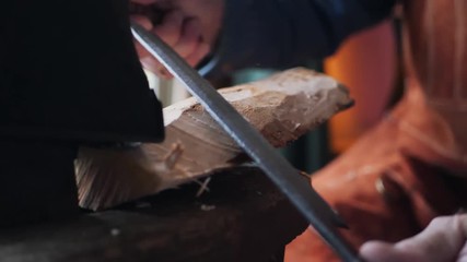 Close Up of Woodworker Shaving Wooden Log on Lathe