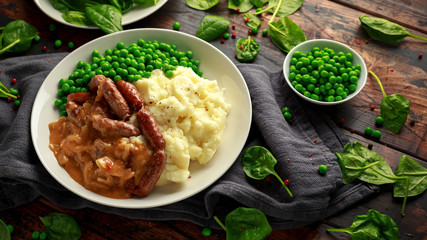 Mashed potatoes and sausages, bangers with onions gravy, green peas