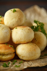 Fresh Garlic Ball bread on black plate on crumpled paper