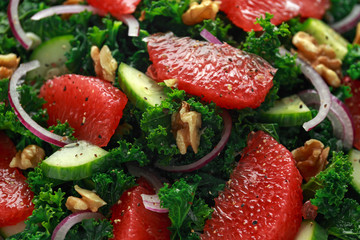 Healthy vegan, vegetarian Grapefruit kale salad with walnuts, red onion and cucumber