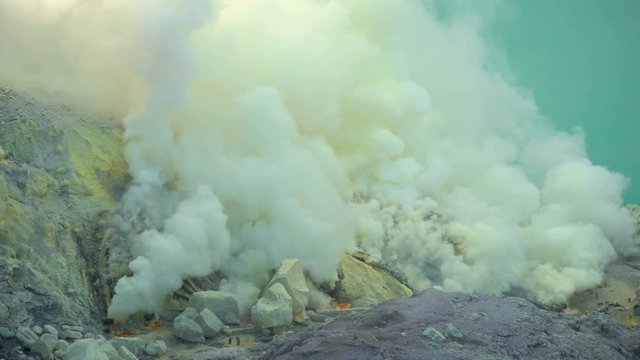 View of sulphur mining mountain volcano crater with acidic lake Ijen Java 