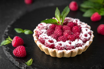 Pastry berry tart. Delicate crispy, crumbly dessert with raspberries and mint. Assorted Confectionery Range.
