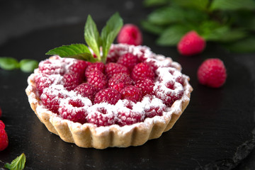 Pastry berry tart. Delicate crispy, crumbly dessert with raspberries and mint. Assorted Confectionery Range.