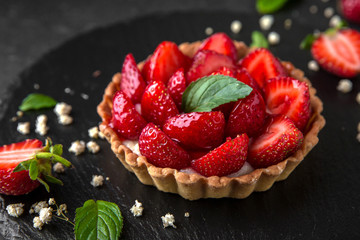 Pastry berry tart. Delicate crispy, crumbly dessert with strawberries and mint. Assorted Confectionery Range.