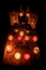 Mix candles, incense and lanterns on rustic wood table