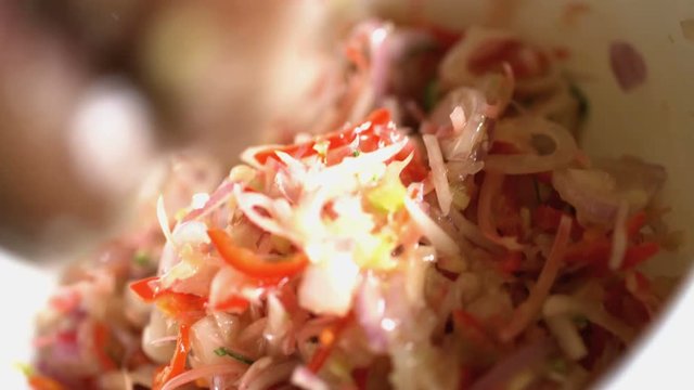 Preparation of shredded healthy raw vegetables for nutritious salsa by chef in Balinese college kitchen