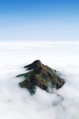 A lush mountain peak above a thick layer of clouds in Chile's Parque Nacional La Campana - 236677162