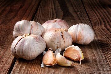 Garlic cloves on a dark rustic wood table