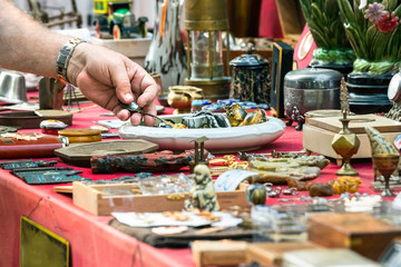 Male hand looking for old objets at a retro - vintage street market in Split, Croatia.