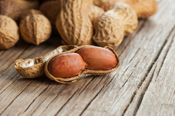 Peanut in nutshell on wooden backrop. Composition of peanuts serving to make oil, peanut butter....