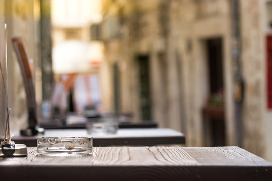 Perspective Of A Wooden Table With An Ashtray Outside A Bar In Split, Croatia.