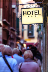 Hotel signboard iluminated on a narrow street in Venice, Italy