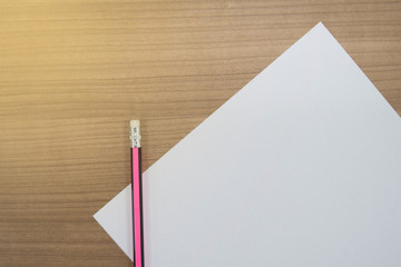 Pencil and white paper on the desk, at work, in the office