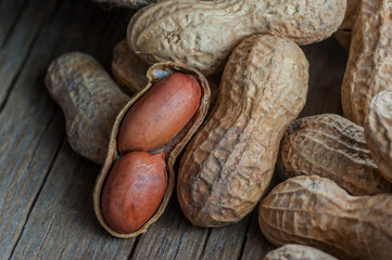 Peanut in nutshell on wooden backrop. Composition of peanuts serving to make oil, peanut butter....
