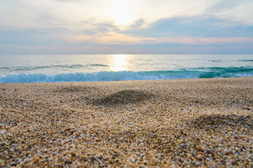 Fototapeta na wymiar Sandy beach with blurred sea on a background on a sunset. 
