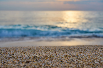 Sandy beach with blurred sea on a background on a sunset.  