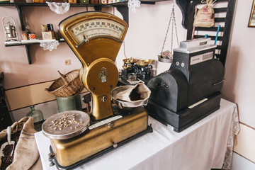 Vintage golden weighing scales as a part of restautant interior