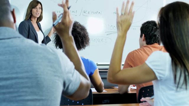 Successful Caucasian American female instructor with class multi ethnic mature students being tutored for retraining 