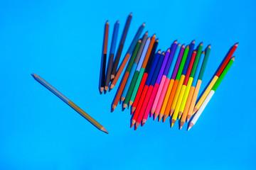 Multicolour pencils isolated on blue background.Close up several colors.