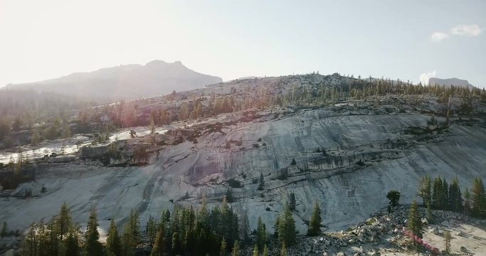 Epic aerial drone shot of amazing white stone rock mountain skyline in sunny summer Yosemite national park California.