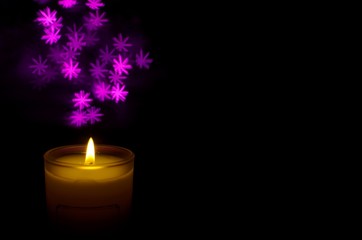 Candle with flame and bokeh light in dark background for praying in Church concept.