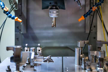 High precision CNC machining center working, operator machining automotive sample part process in factory