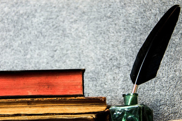 Old inkwell and quill pen. Vintage background. Free space for text.