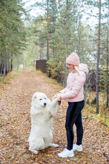A pretty woman is walking her dog