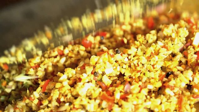 Preparation by hand of Basa gede using nutritious spices and chopping with traditional Blakas in Balinese kitchen