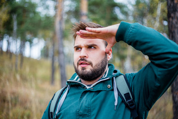 male hiker is looking at a distance