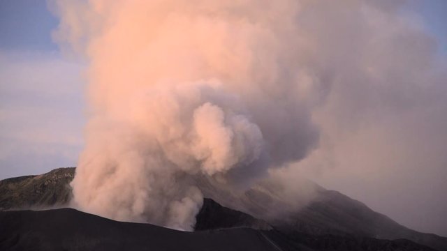 Travel destination Mt Bromo volcano erupting smoke cloud in Java Indonesia