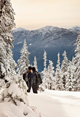couple enjoying the frozen and snowy landscape of the olympic mountains in washington state