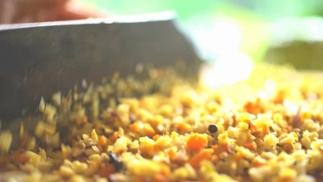 Preparation by hand of Basa gede using nutritious spices and chopping with traditional Blakas in Balinese kitchen