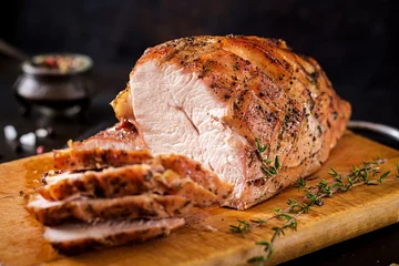  Roasted sliced Christmas ham of turkey on dark rustic background. Festival food. © timolina