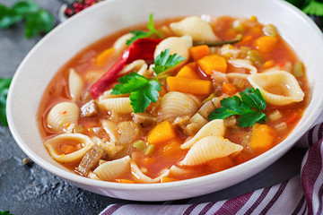 Minestrone, italian vegetable soup with pasta on  table. Vegan food