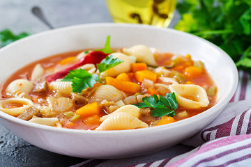 Minestrone, italian vegetable soup with pasta on  table. Vegan food