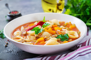 Minestrone, italian vegetable soup with pasta on  table. Vegan food