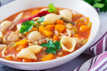 Minestrone, italian vegetable soup with pasta on  table. Vegan food