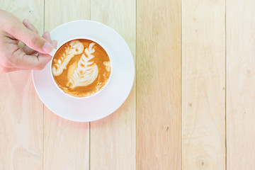 hot cappuccino coffee with nice pattern foam on table / Hot coffee on plate