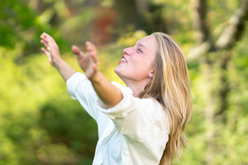 Euphoric woman laughing outdoors in nature