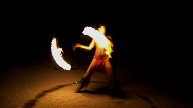 Male Fire dancer with illuminated flaming torch performing the Art of Fire dancing a traditional culture in French Polynesia South Pacific
