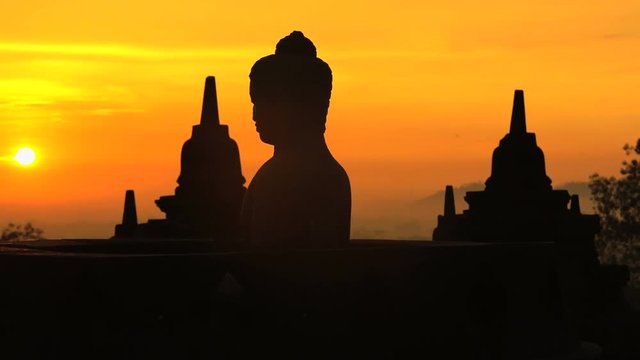 Sunrise over Borobudur a religious ruined temple an ancient wonder Java