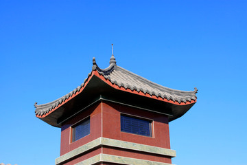 Fototapeta na wymiar Chinese architectural style tower under blue sky