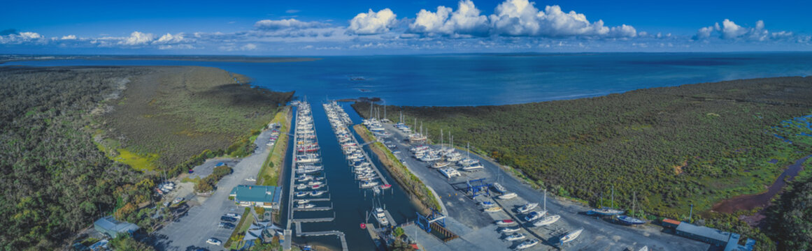 Wide panorama of Yaringa Boat Harbour and ocean coastline on summer day