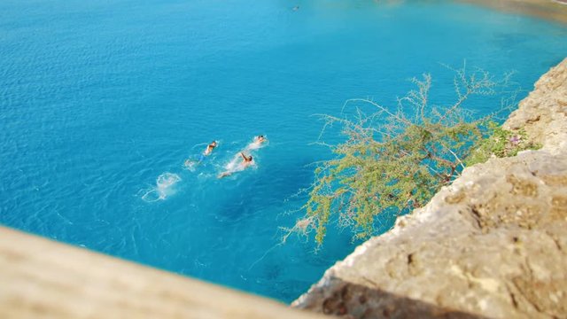 Aerial view of three people swimming to shore at Playa Forti, Curacao, Caribbean