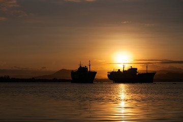 Beautiful sunrise seascape view with boat in phuket island.