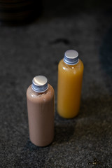 Spa cosmetics in plastic bottles on dark gray concrete table, bathroom interior. Beauty blogger, salon therapy, branding mockup, package, minimalism concept.