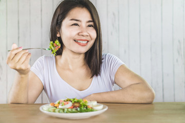 healthy beautiful Asian woman eating salad for diet 