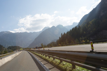 Road, green meadows, blue sky