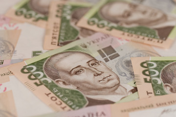 A close-up of a pattern of many Ukrainian currency banknotes with a par value of 500 hryvnia. Background image on business in Ukraine.